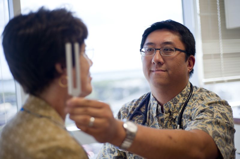 Dr. Huidy Shu examining a patient