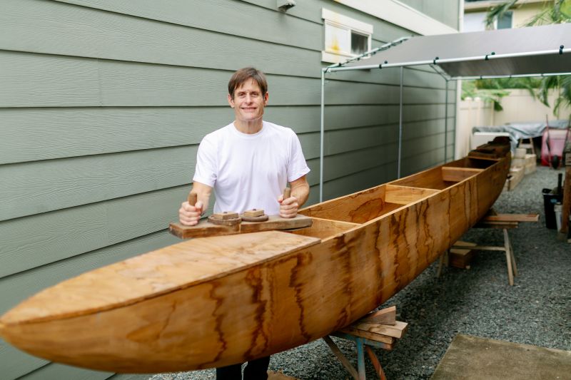 Rick Hobson finishing his handcrafted koa fishing canoe