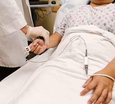 patient with heart care doctor bedside