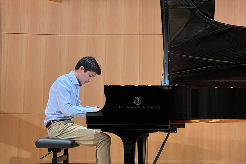 Jacob Wu playing his fundraising piano recital in honor of his mom's care at Wilcox.