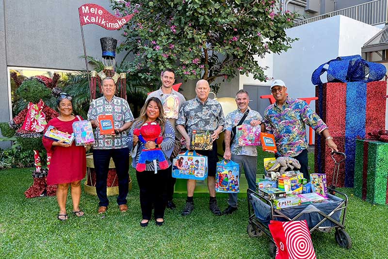 Marriott employees holding donated toys.