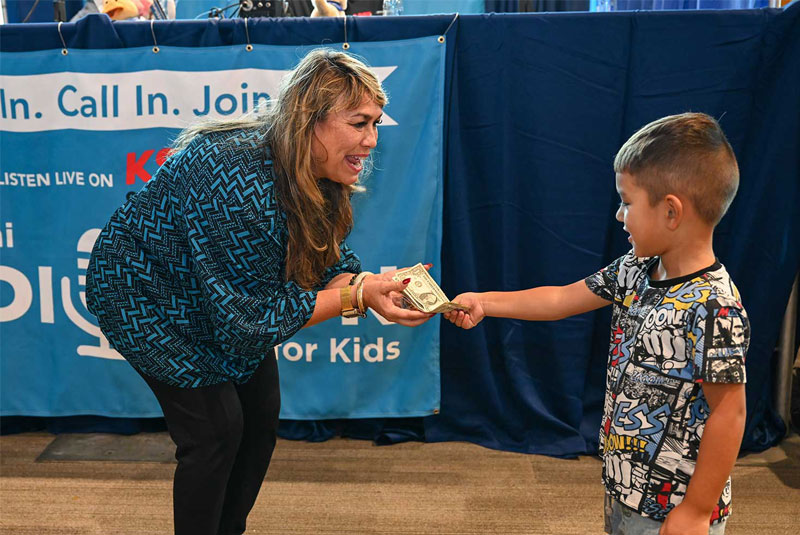 Sweetie Pacarro accepts a gift from a young donor.