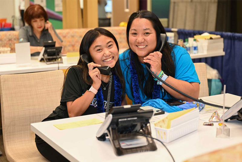 Keely Tamayose and her mother, Dayle, answer phones during Radiothon to accept call-in donations.