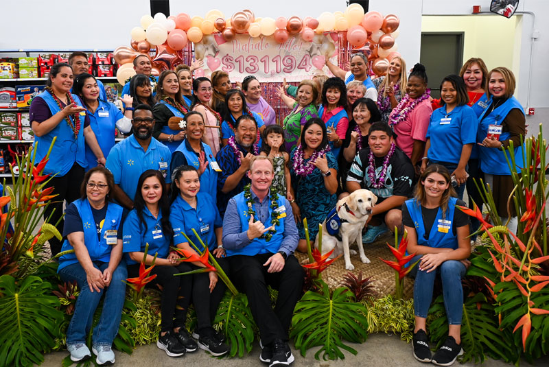 A group of Hilo Walmart associates with the 2023 Children's Miracle Network Champion.