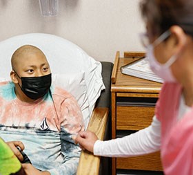 Young cancer patient with a nurse