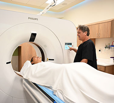 Young woman undergoing a CT scan.