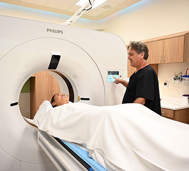 Young woman undergoing a CT scan.